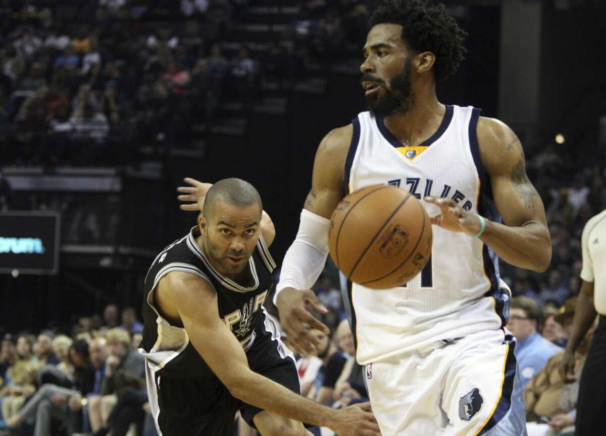 San Antonio Spurs' Tony Parker watches the ball as Memphis Grizzlies' Mike Conley looks for an open shot in the first half of an NBA basketball game Saturday, March 18, 2017, in Memphis, Tenn. (AP Photo/Karen Pulfer Focht)