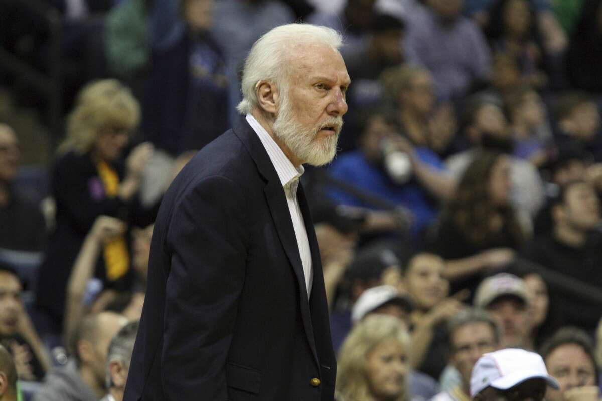 San Antonio Spurs coach Gregg Popovich reacts to a call in the first half of an NBA basketball game against the Memphis Grizzlies, Saturday, March 18, 2017, in Memphis, Tenn. (AP Photo/Karen Pulfer Focht)