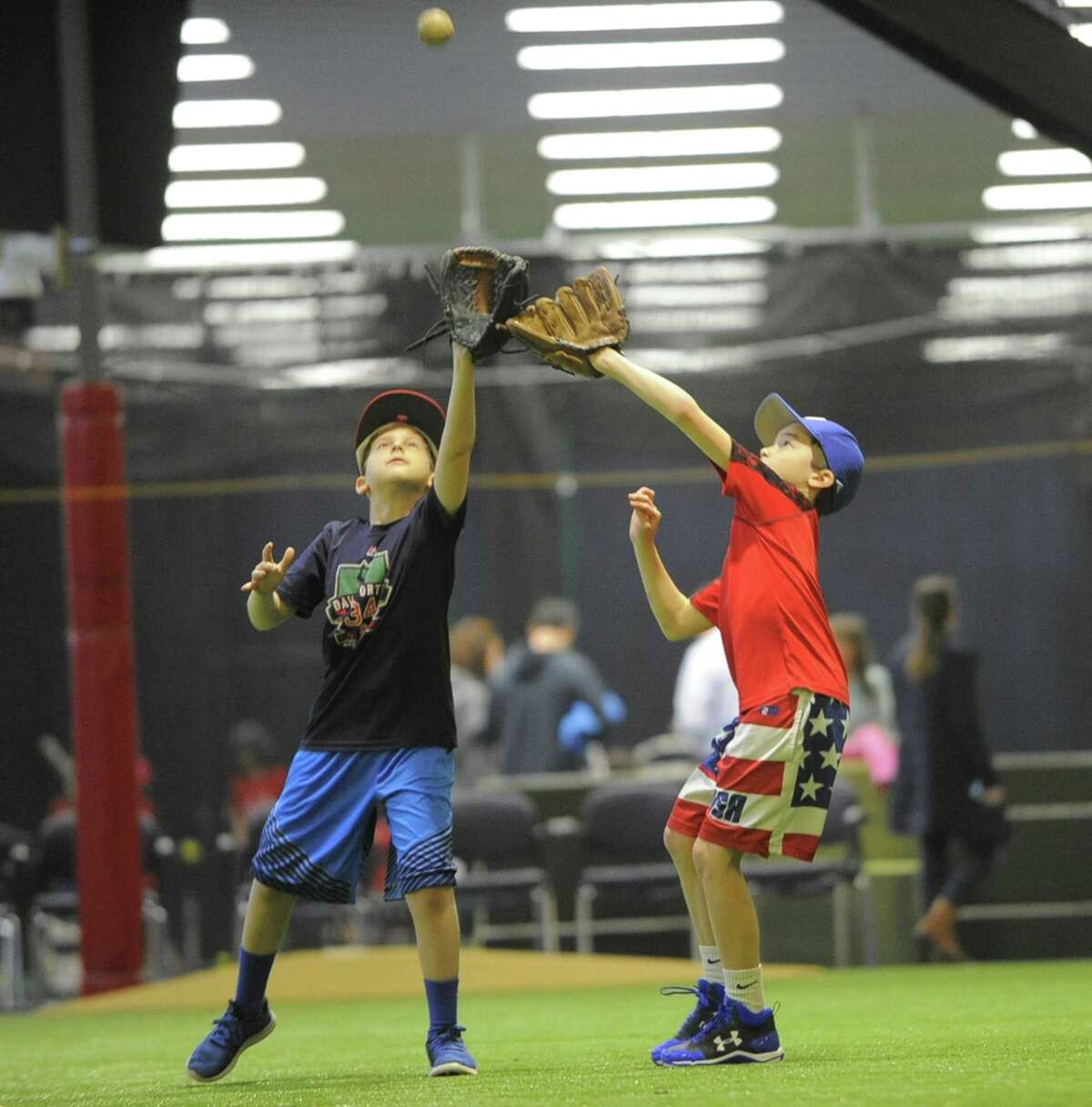 Matthew Goodman, 11, of Stamford and Georgie Childs, 11, of Darien participate in a baseball skills clinic at the new Bobby Valentine's Sports Academy complex in Stamford, Conn. on March 17, 2017. The newly opened State of the Art indoor baseball teaching facility accommodates a full size Major League infield diamond, batting and pitching cages, as well as a workout weight room and gym.
