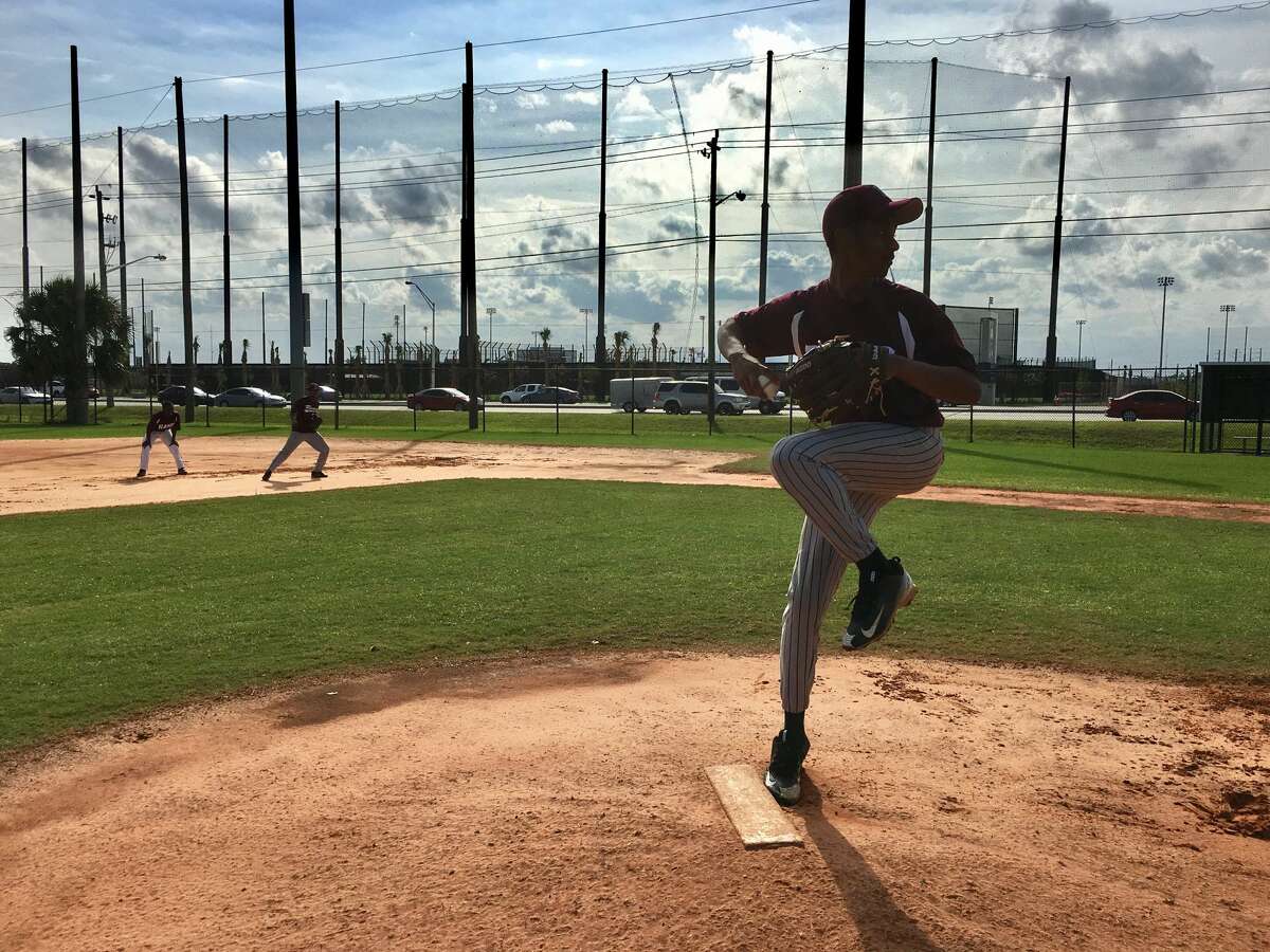 Najair Chambers pitches at practice for the Palm Beach Lakes High School baseball team. The school is across the street from the Astros' new spring training facility, Ballpark of Palm Beaches.