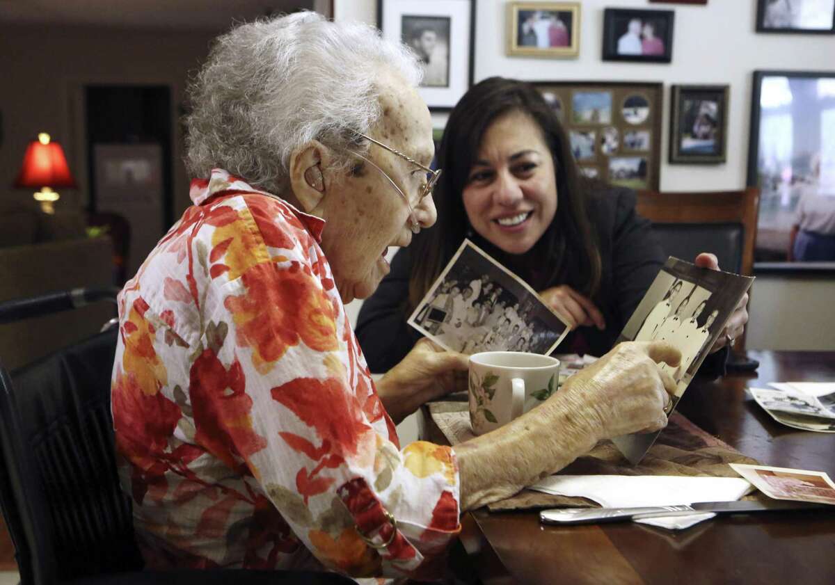 Lucy Coffey and Queta Rodriguez go through pictures taken while Coffey was in Japan. Coffey is the nation's oldest woman veteran, serving in the procurement office of the Women's Army Auxiliary Corps during World War II. Today, she is 108 years old. A group in Austin wants to send her to Washington for an honor flight and possibly meet with Vice President Biden. Coffey enlisted in the Women's Army Auxiliary Corps in 1943 and landed in Japan, where she served in the procurement office and worked for 10 years after the war ended. She worked in the procurement office at Kelly from 1958 until her retirement in 1971, and is only a few days younger than America’s oldest male veteran, Richard Overton.