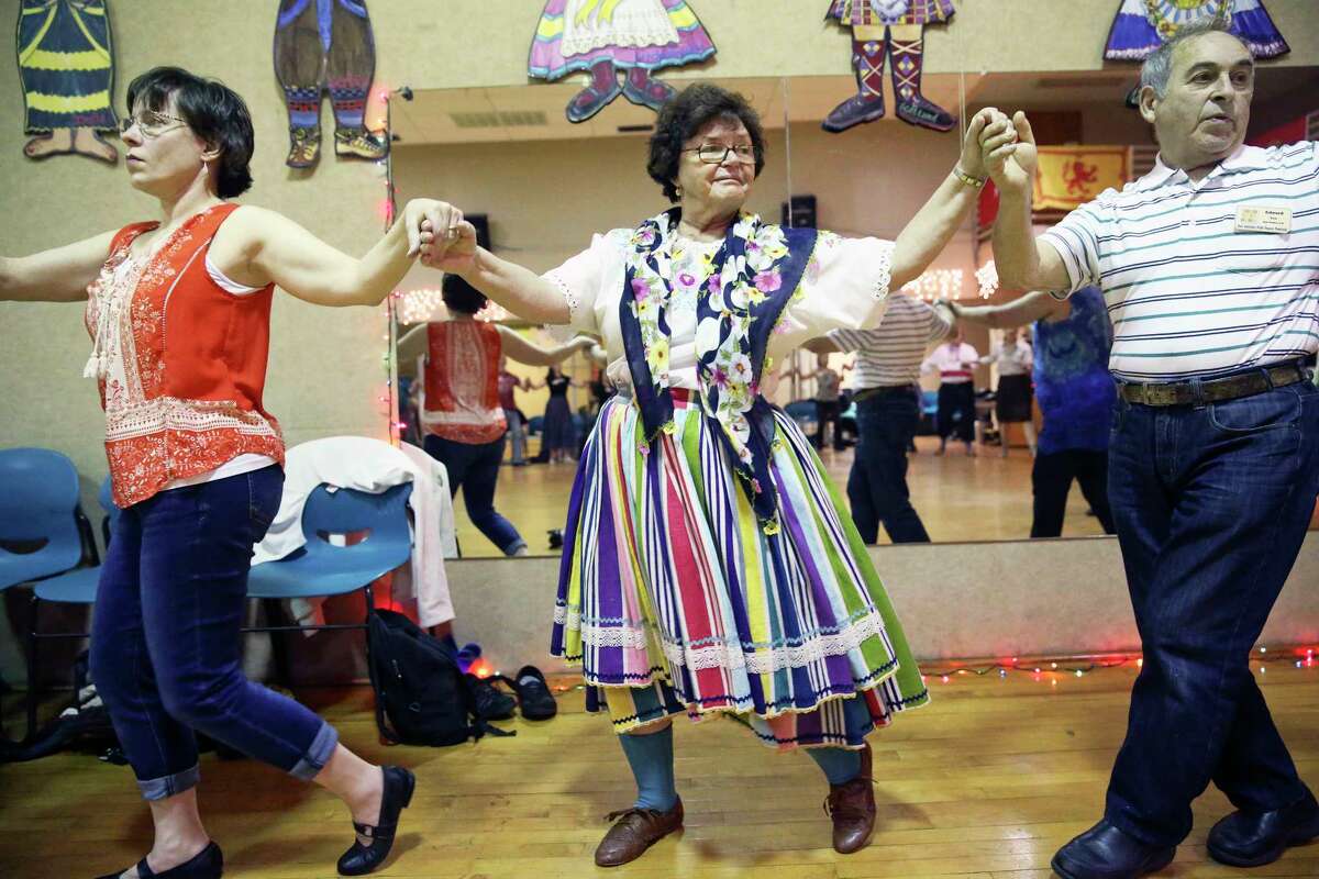 Dancers turn in a big circle as the 59th annual San Antonio Folk Dance Festival offers ethnic dance workshops at the International Folk Culture Center at Our Lady of the Lake University on March 17, 2017. From left are Stefanie Knopp from Newton, Kansas, Pauline Klak from San Pedro , California and Eduard Klak from San Pedro , California.