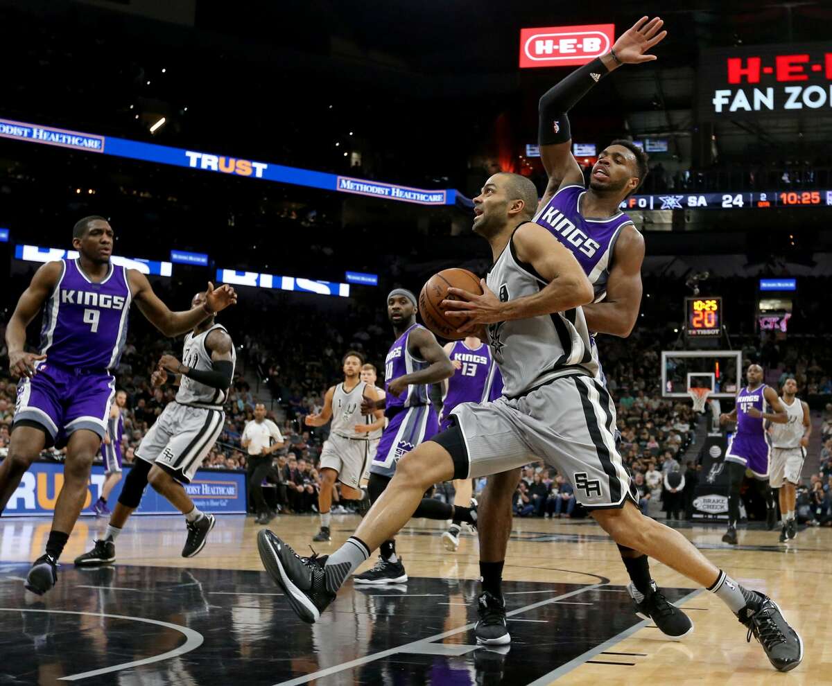 San Antonio Spurs' Tony Parker drives to the basket around Sacramento Kings' Buddy Hield during first half action Sunday March 19, 2017 at the AT&T Center.