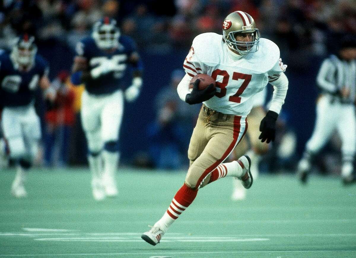 San Francisco 49ers wide receiver Dwight Clark (87) runs with the ball after catching a pass during the NFL 1985 NFC Divisional playoff game against the New York Giants on December 29, 1985 in East Rutherford, New Jersey. The Giants won the game 17-3. (AP Photo/Paul Spinelli)