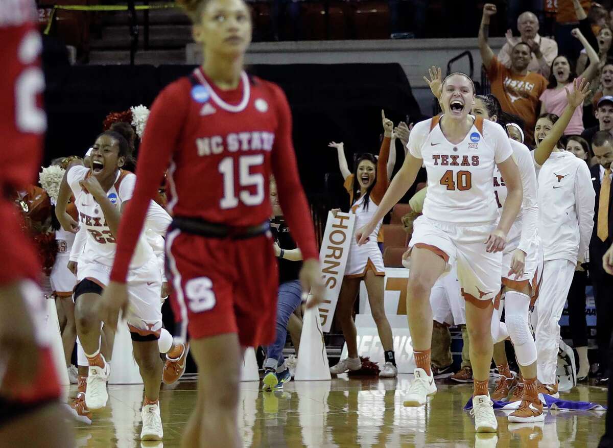 North Carolina State's Lucky Rudd (15) can't bear to watch as Texas' Ariel Atkins, left, Kelsey Lang (40) and their teammates celebrate Sunday's win that sent the Longhorns to the Sweet 16.
