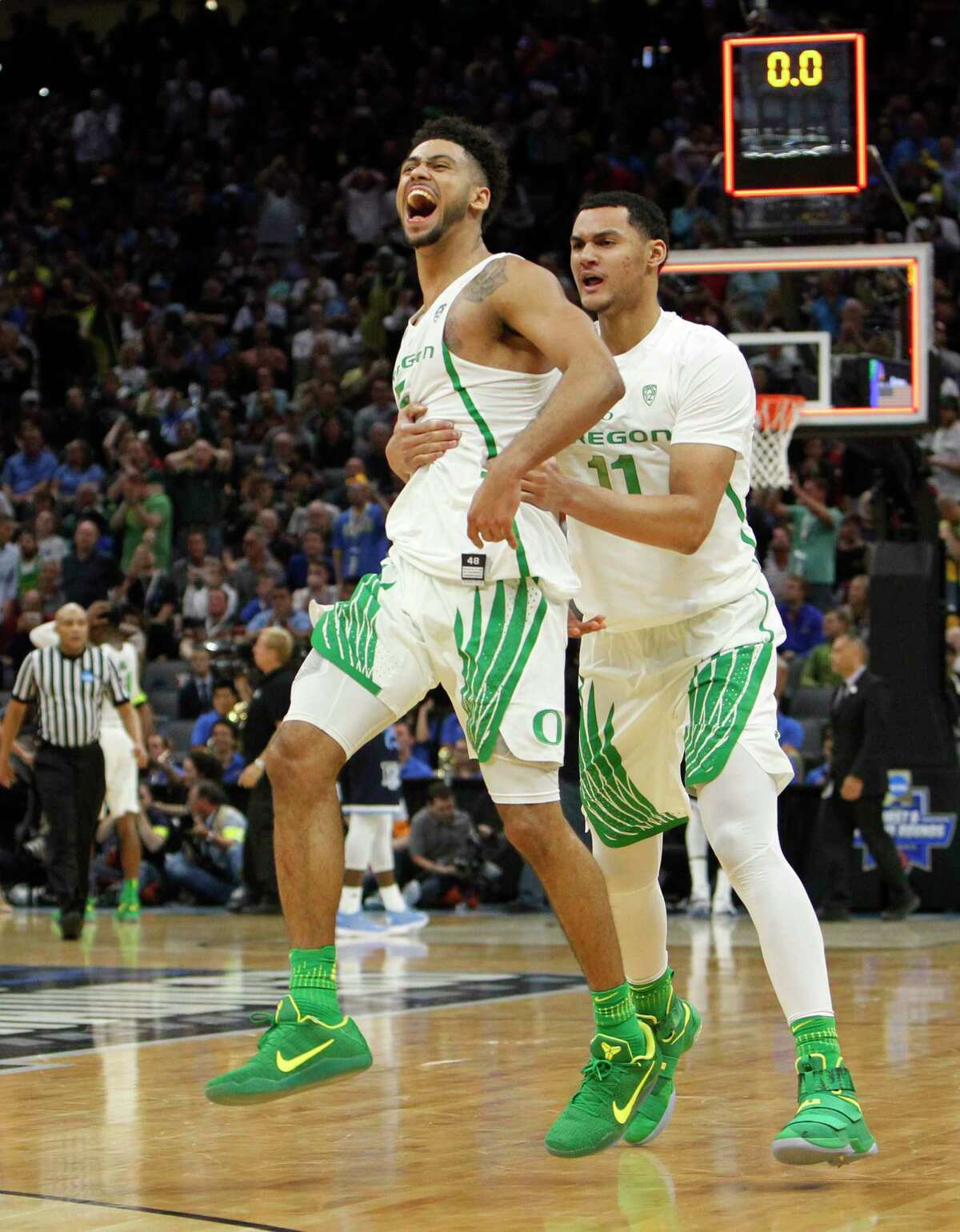 Oregon guard Tyler Dorsey (5) celebrates with teammate Keith Smith (11) after their win over Rhode Island during a second-round game in the NCAA college basketball tournament in Sacramento, Calif., Sunday, March 19, 2017. Oregon won 75-72. (AP Photo/Steve Yeater)
