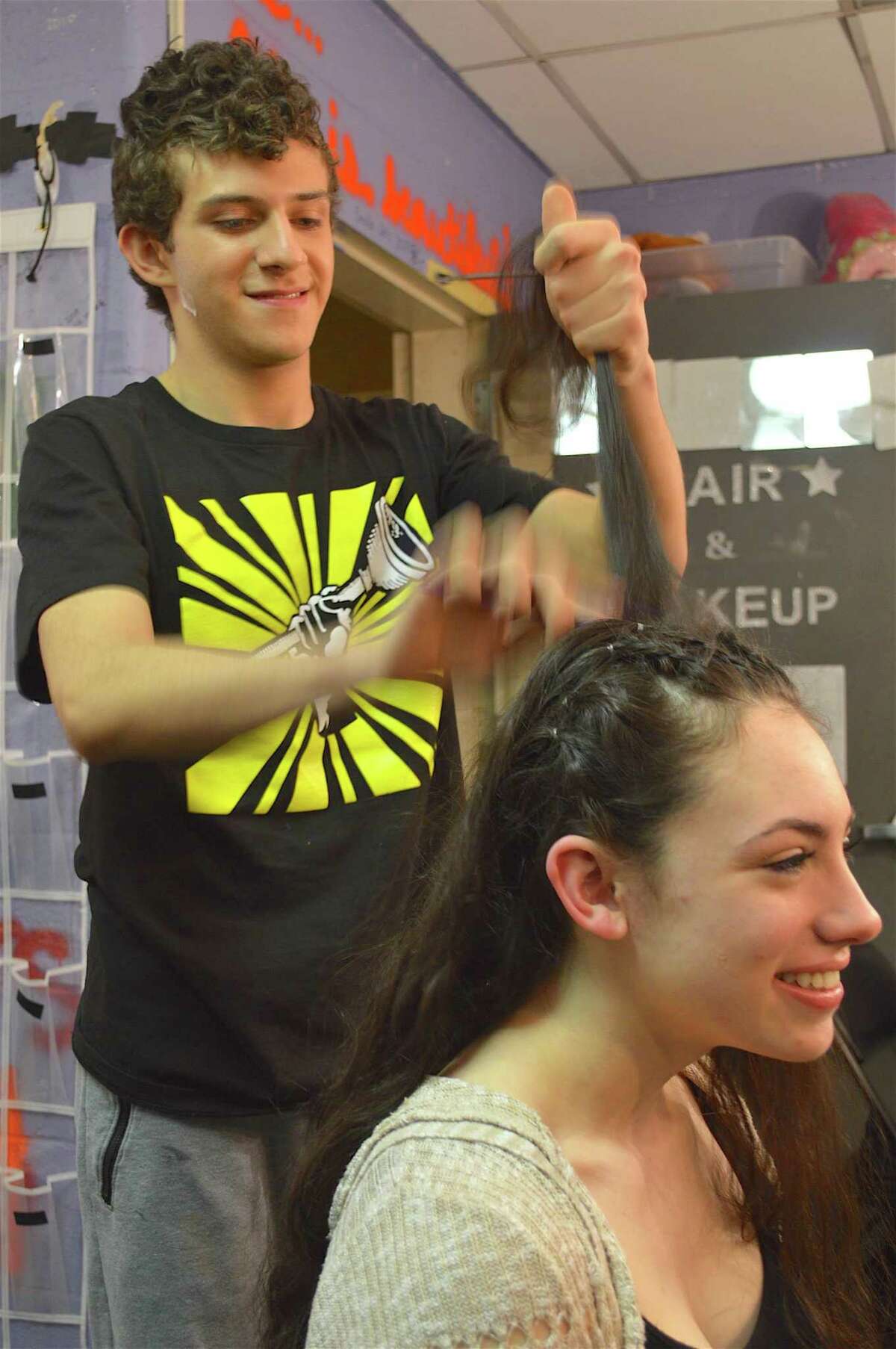 Sophia Sherman, 16, has her hair done by Antonio Antonelli, 15, in preparation for the Staples High School Players' performance of "Urinetown, the Musical," Friday, March 17, 2017, in Westport, Conn. The Staples High School Players’ spring production of “Urinetown, the Musical” got under way last weekend, and continues this Friday. Cast and crew assembled early in the afternoon to prepare for the show — donning wigs, applying makeup, and making last-minute adjustments to the set. The 2001 musical, which parodies other musicals and a range of social institutions, runs Friday and Saturday, March 24 and 25. For more information visit www.staplesplayers.com.