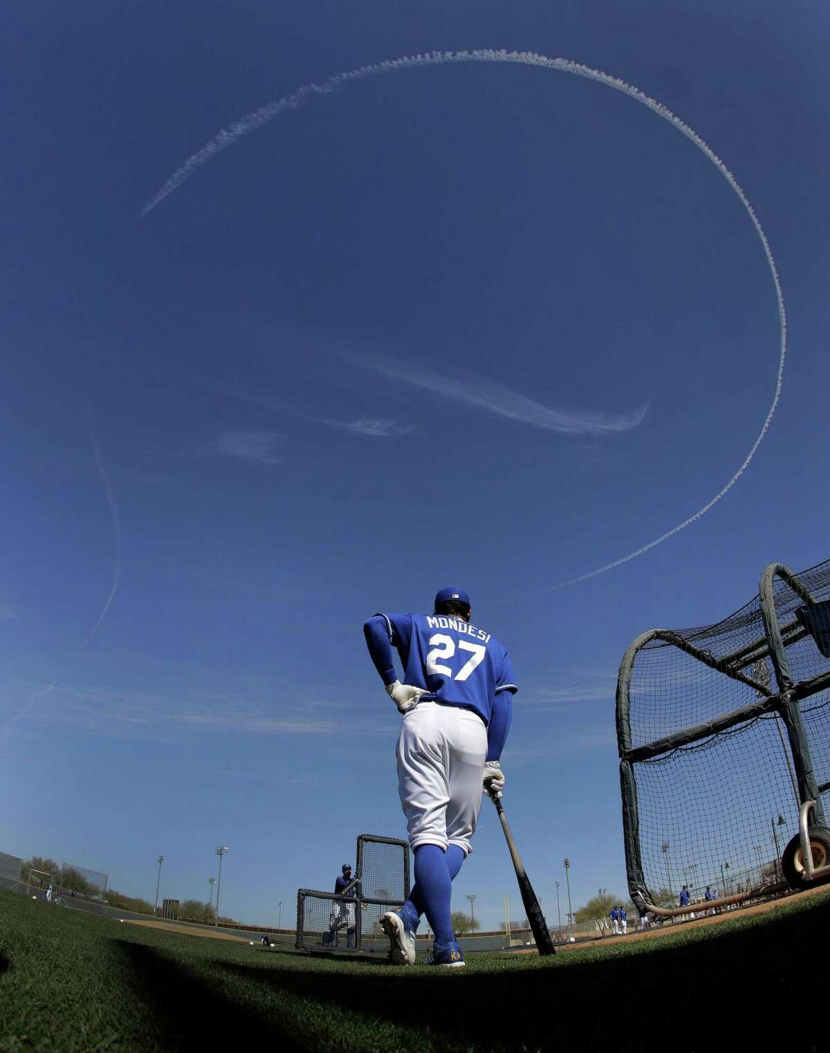 Kansas City Royals’ Raul Mondesi waits to bat as a jet circles overhead during spring training baseball practice on Feb. 24, 2017, in Surprise, Ariz.