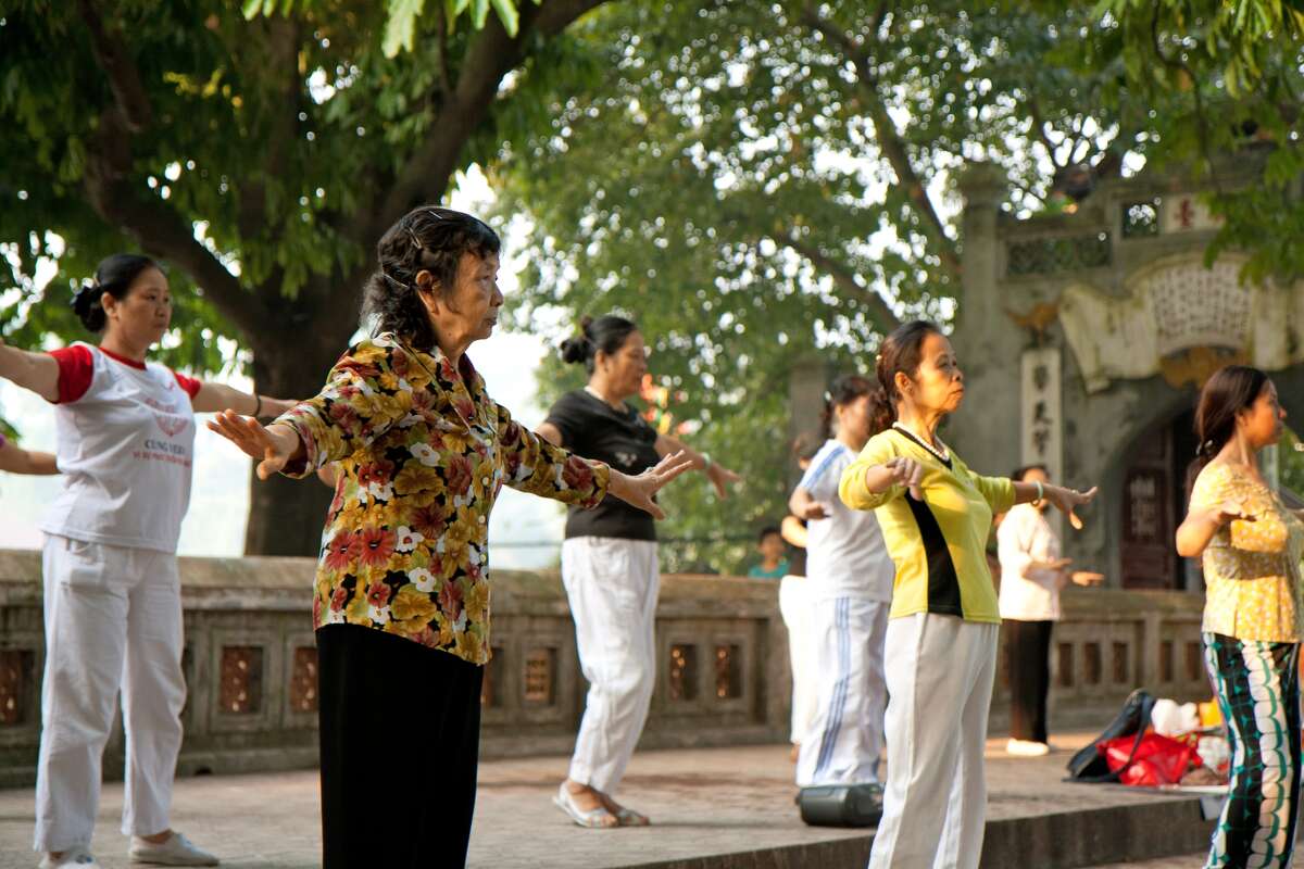A group of local women seniors dance and exercise at the Hoan Kiem Lake park in Hanoi, Vietnam.