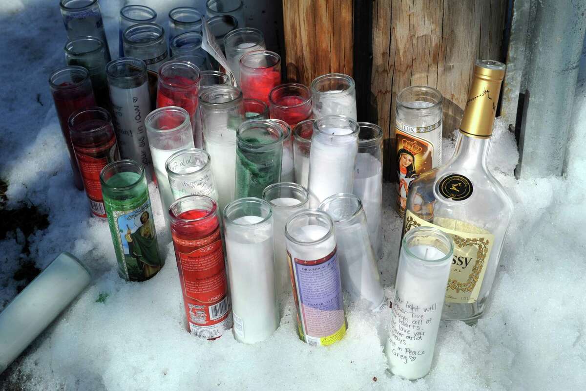 Candles an an empty liquor bottle placed near the apartment building at 201 Bretton St., in Bridgeport, Conn., where Gregory Francilme, 19, was shot Saturday afternoon, seen here March 20, 2017. Francilme died from his injury.