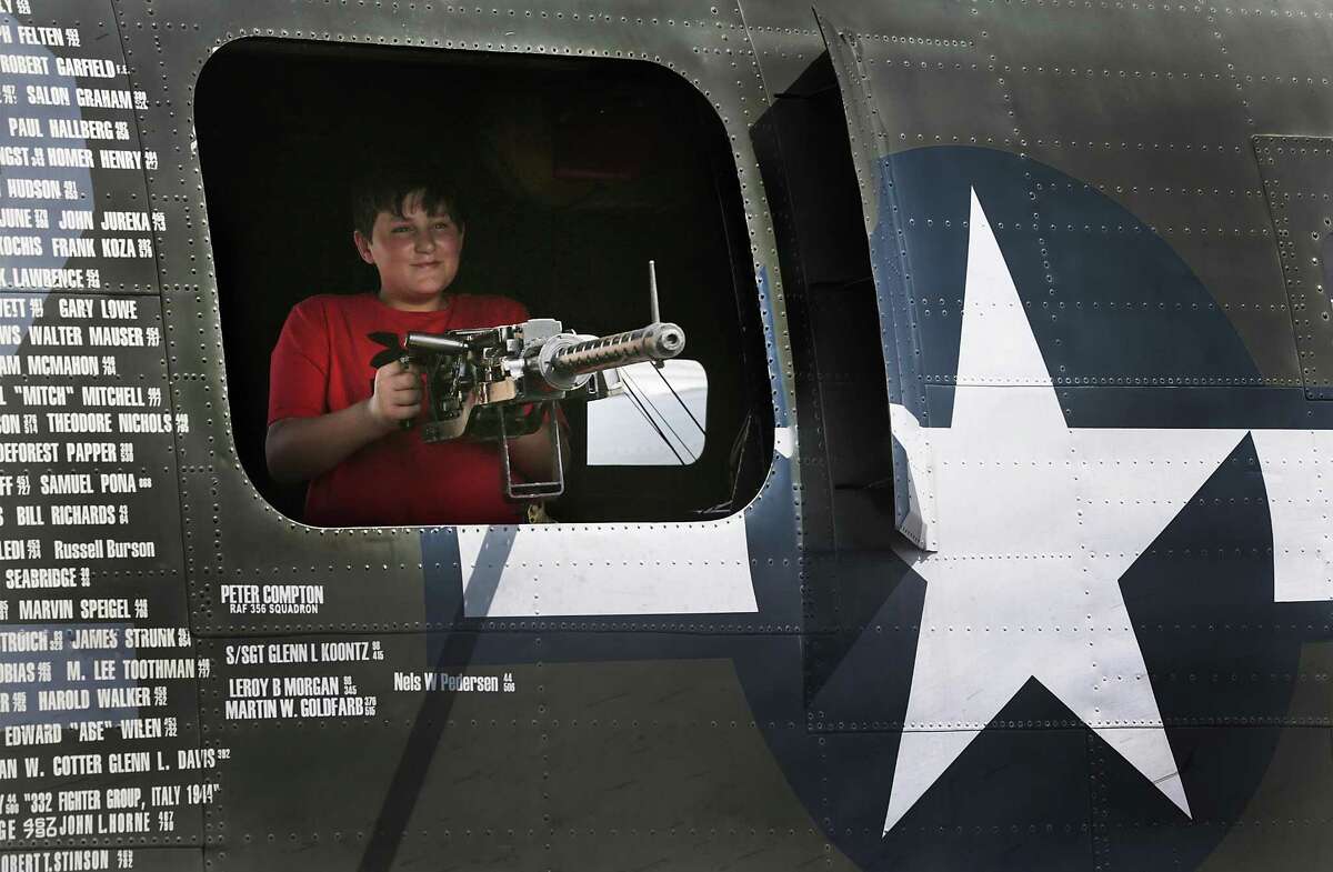 Jacob Stidham checks out the gun in the gunners window of a B-24J during Wings of Freedom Tour display at Stinson Municipal Airport on Friday, March 17, 2017. The display, which is open to visits and flights, will go on thru Sunday, March 19th.