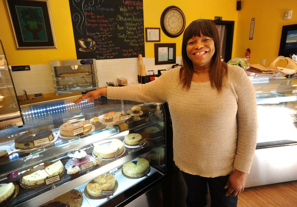 Sandra Williams stands in front of a case of her many cheesecake varieties at La Signature Cheesecakes in the Arcade Mall at 1001 Main Street in downtown Bridgeport, Conn. on Thursday, March 16, 2017.
