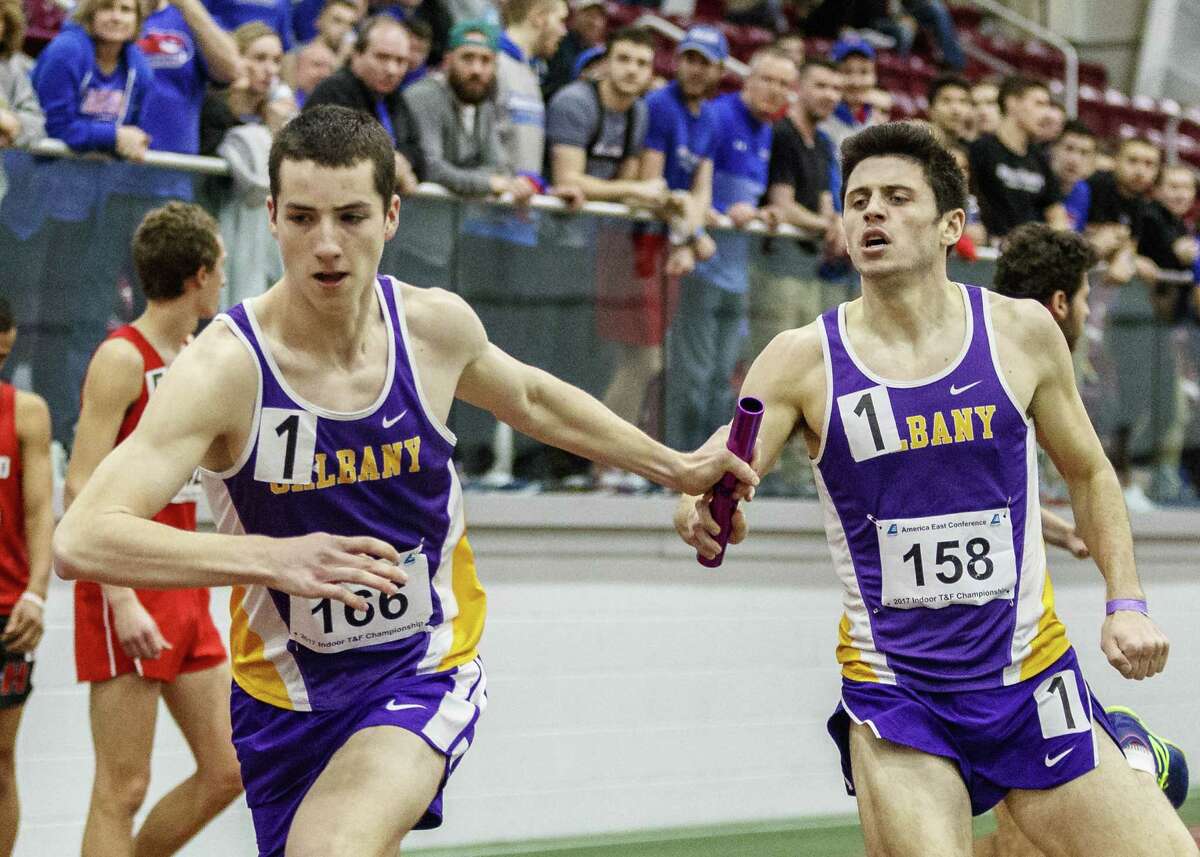 Jake Johnson (No. 158) runs a relay with Joey Somerville of Wynantskill (Columbia High). (Doug Austin / SUNY Albany)