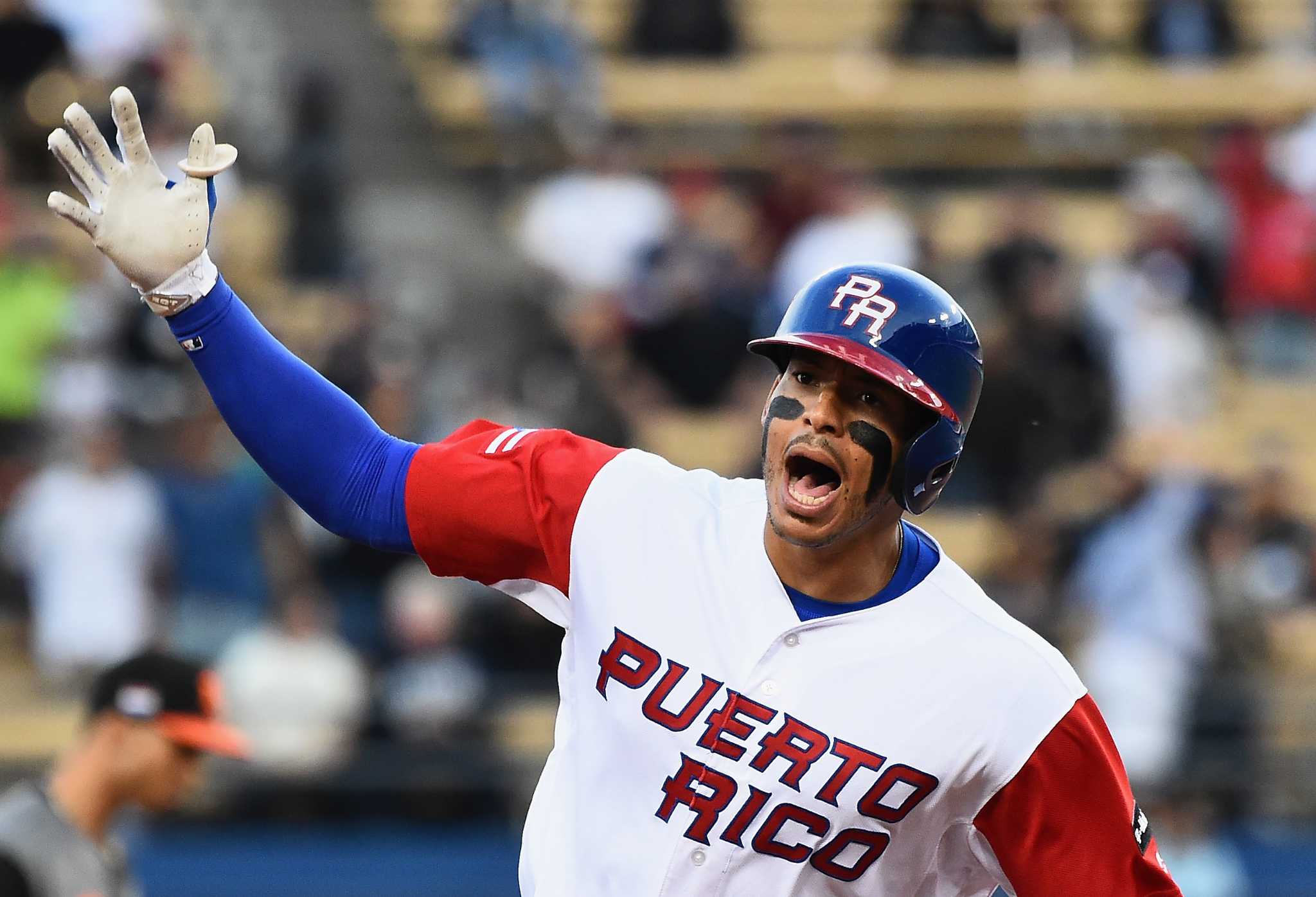 Francisco Lindor of Team Puerto Rico signs a jersey with Puerto