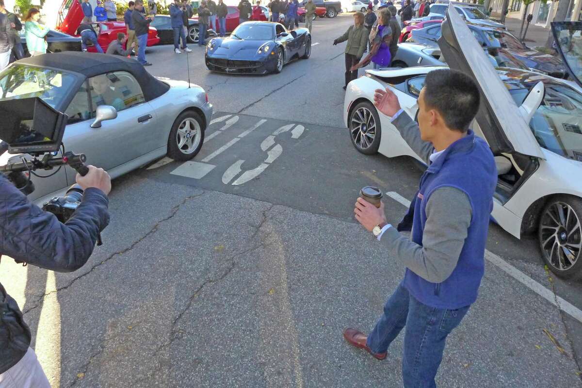 Greenwich Cars & Coffee co-founder Steven Fong welcomes the driver of a Pagani Huayra to the group's first event, held on Oct. 23, 2016, on Greenwich Ave., in Greenwich, Conn.