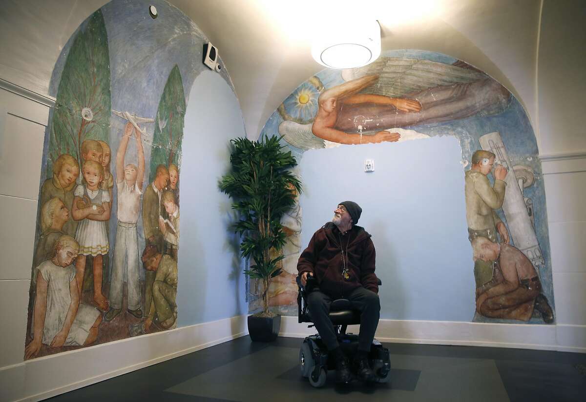 Richard Smallcomb views murals that were altered in previous developments inside the restored Richardson Hall on Laguna Street in San Francisco, Calif. on Tuesday, March 21, 2017. Smallcomb was among the first residents to move into Richardson in November, which at one time was part of the San Francisco State Teacher's College and was recently renovated as LGBT-friendly affordable housing for seniors.