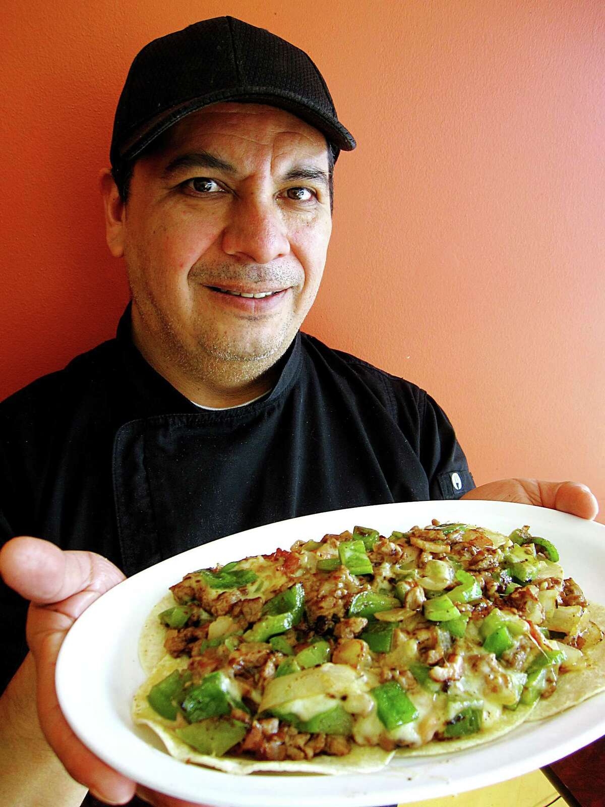 Eduardo Gonzalez is the manager of Que Taco on Blanco Road. One of the shop's specialites is tacos de alambre, a mix of grilled steak, onions, bell peppers, cheese and bacon.