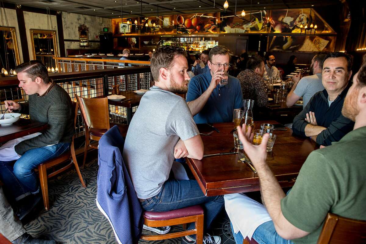 Front table, from right: Caleb O'Connell, Rob Pereira, Kevin Moore and Evan Zavadil chat over lunch at Zero Zero, an Italian restaurant, on Tuesday, March 21, 2017, in San Francisco, Calif. The restaurant uses OpenTable to provide online reservations. OpenTable revealed a campaign today that spotlights the impact of reservation no-shows on the restaurant industry.