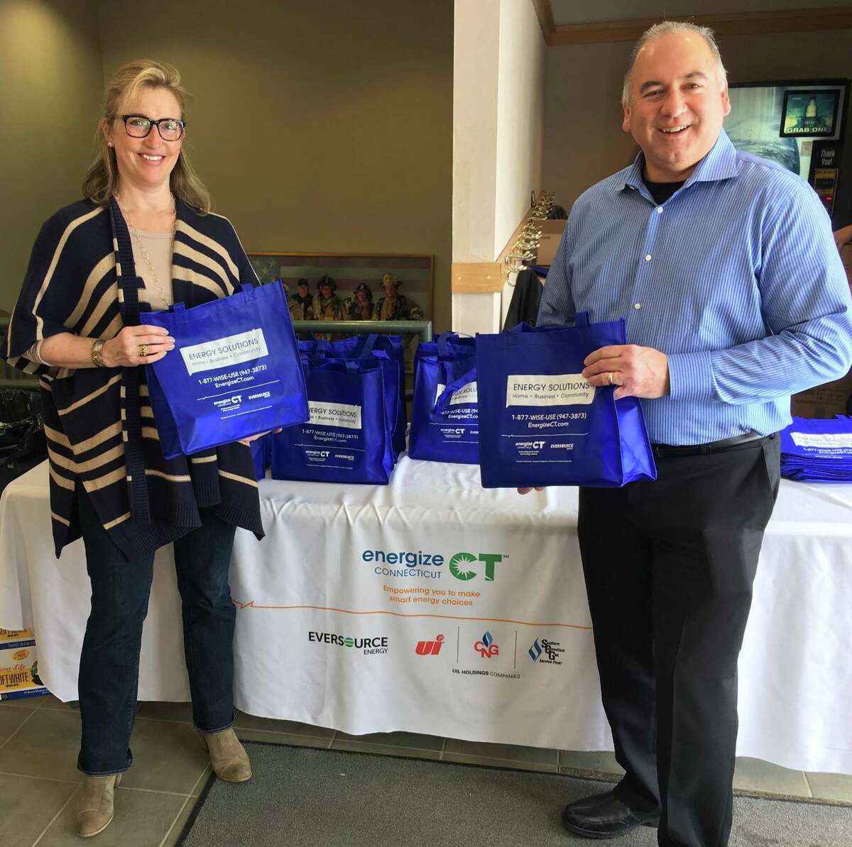 Redding First Selectman Julia Pemberton and Ron Araujo, Eversource Energy Efficiency, handing out LEDs during the community bulb swap.