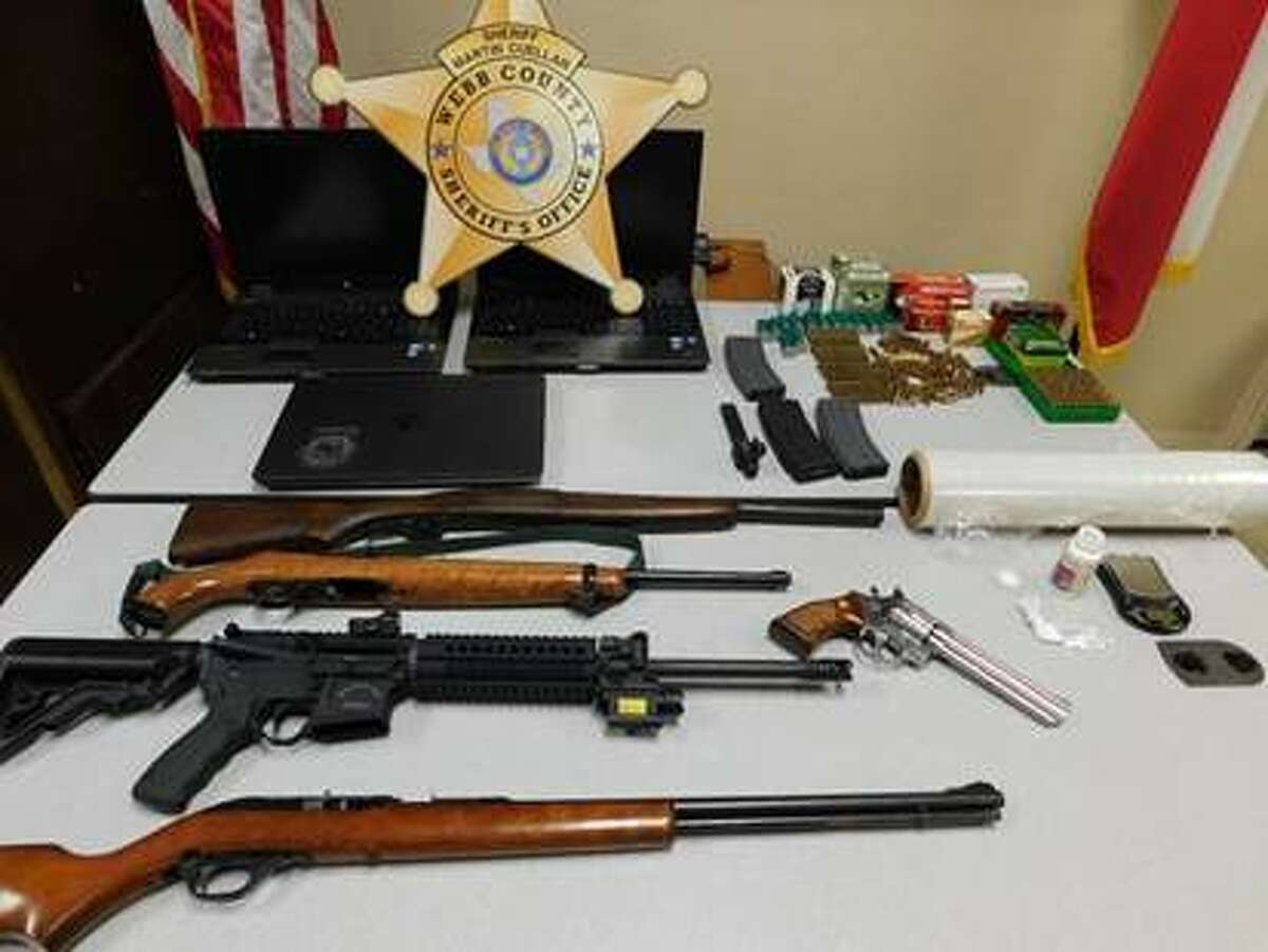 The seized firearms and stolen laptops are pictured.
