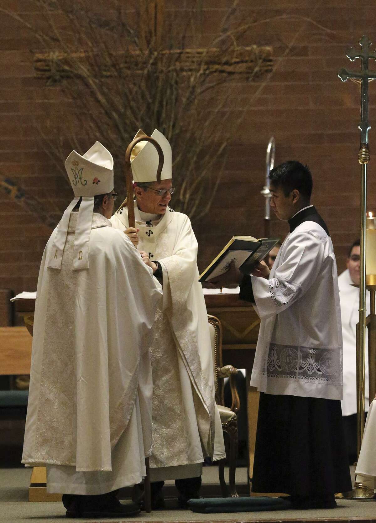 Archbishop Gustavo Garcia-Siller (center) hands Michael Boulette a crosier Monday March 20, 2017 during Boulette's ordination at St. Mark the Evangelist Catholic Parish. Boulette is now Auxiliary Bishop of the Archdiocese of San Antonio.