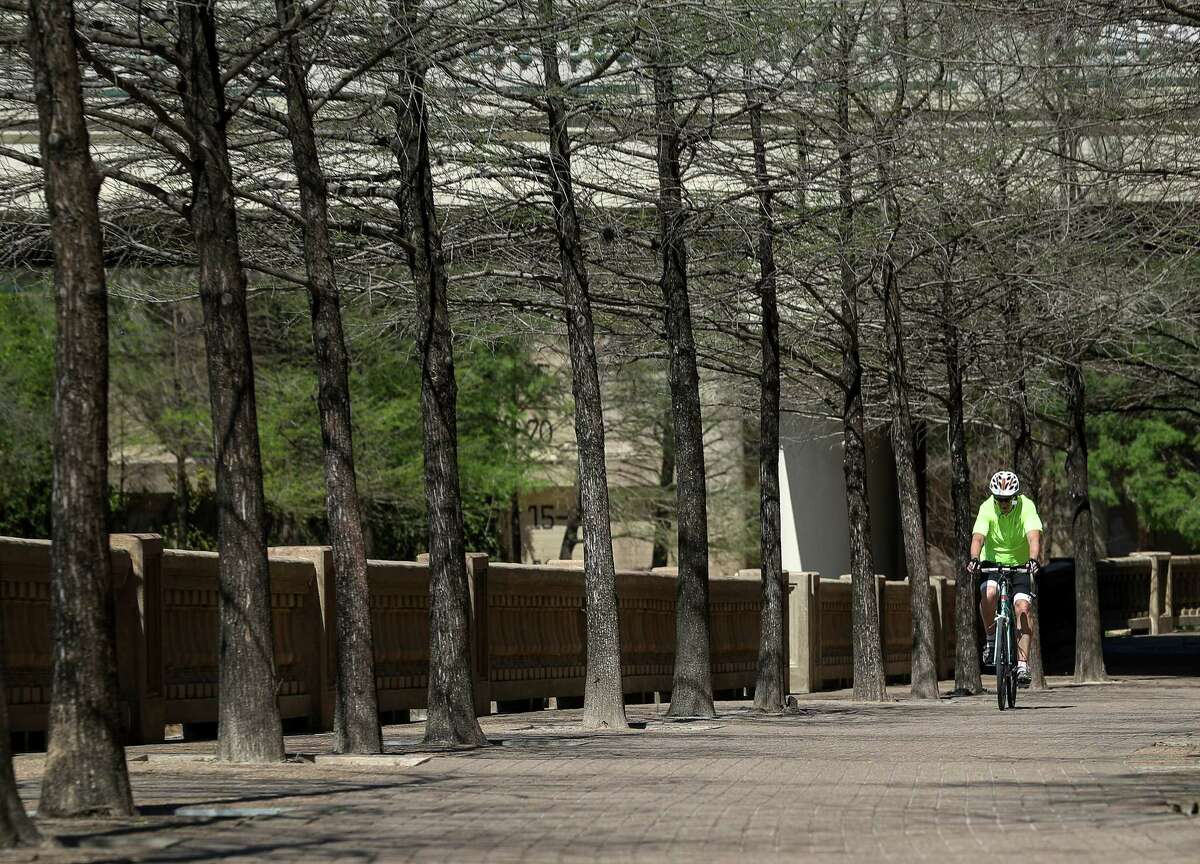 A cyclist rides on a trail along Buffalo Bayou near downtown Houston on March 21. Officials would like to connect the bayou trails via north-south connections along utility corridors.