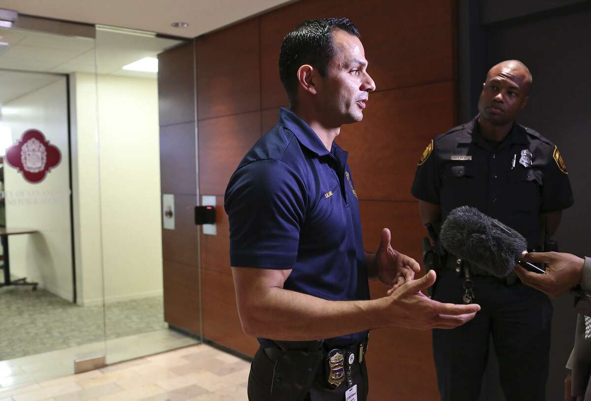 SAPD Spokesman Sgt. Jesse Salame, next to Officer Doug Greene, right, speaks to the media after attorney Daryl Washington, the attorney representing the family of Marquise Jones, held a press conference announcing two new witnesses in the civil suit against the city in the case of the fatal shooting of Jones in 2014, at Frost Bank in San Antonio on Friday, April 29, 2016. Jones was fatally shot by SAPD officer Robert Encina on Feb. 28, 2014.