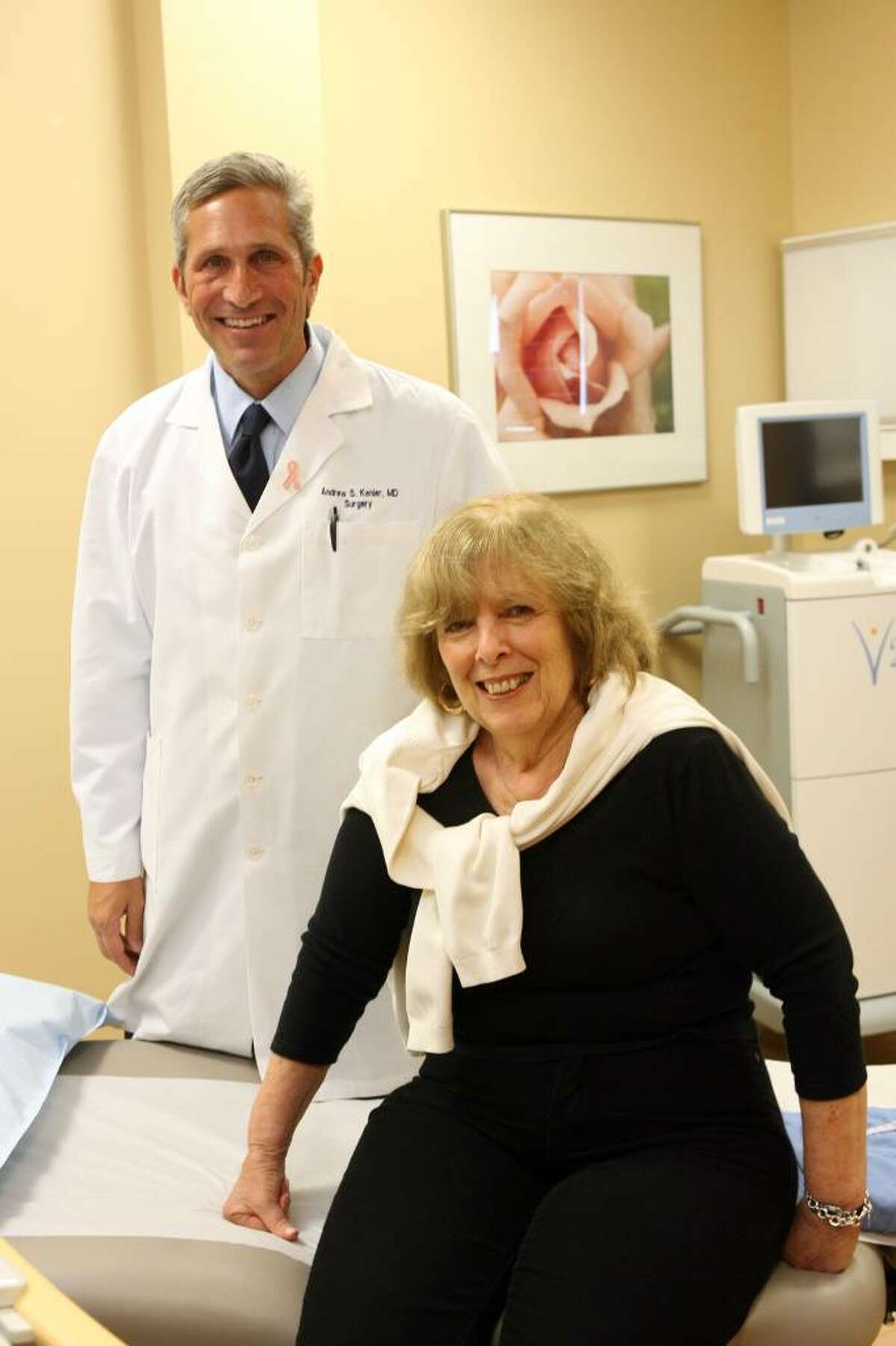 Dr Andrew Kenler stands in his Trumbull office with his patient, Judith Kudikoff of Bridgeport. Kenler ran a trial for a new treatment for breast cancer, which successfully treated Kudikoff.