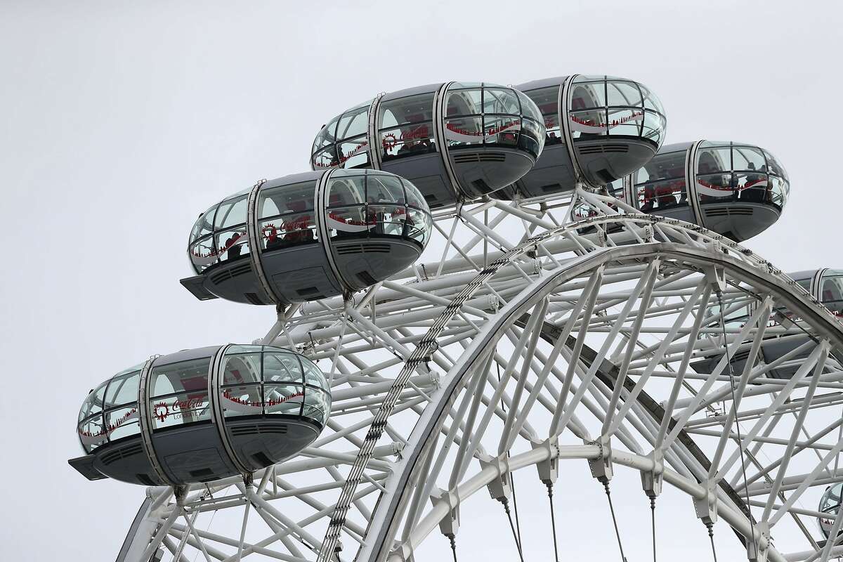 People remain in pods on the London Eye after it was stopped, after a policeman was stabbed and his apparent attacker shot by officers in a major security incident near to the Houses of Parliament in London, Wednesday March 22, 2017. In a separate incident a car drove into a pedestrian on nearby Westminster Bridge. Authorities said they were treating the attack as a "terrorist incident until we know otherwise." (Jonathan Brady/PA via AP)