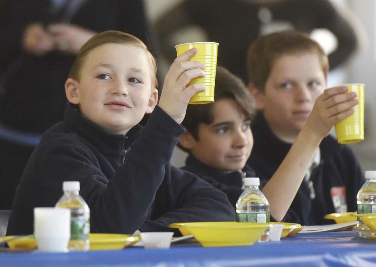 GCS fifth-grader Christian Sorbera, left, raises a glass during the Passover Seder at Greenwich Catholic School in Greenwich, Conn. Wednesday, March 22, 2017. As an annual traditional, Temple Sholom Rabbi Mitchell M. Hurvitz led GCS fifth-graders through a traditional Passover meal to highlight the similarities between Judaism and Catholicism, and and stress acceptance of all religions.