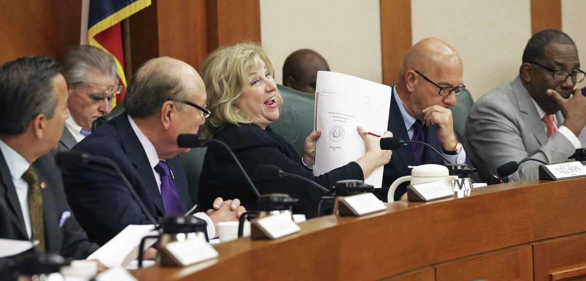 Chairman Senator Jane Nelson gleefully hoists the large volume which is the final draft as the Texas Senate Finance Committee votes out its version of the state spending plan for the next two years on March 22, 2017.