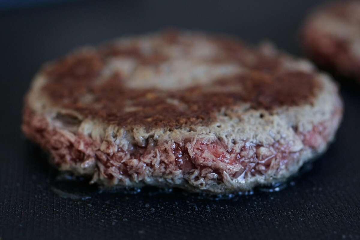 A non-meat burger, made by Impossible Foods, sizzles on a skillet, during a press event at the Impossible Foods headquarters in Redwood City, California, on Thursday, Oct. 6, 2016.