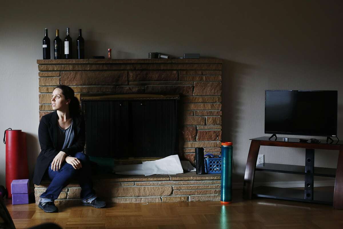 Lolly Mitchell of Redwood City sits for a portrait in her living room nearly empty of furniture on Wednesday, March 22, 2017 in Redwood City, Calif. Mitchell is in the midst of moving to a new home in Southern California.