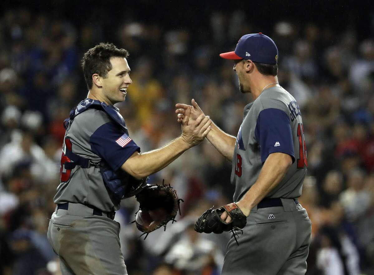 United States' Buster Posey and Luke Gregerson celebrate after the United States defeated Japan, 2-1, in a semifinal in the World Baseball Classic in Los Angeles, Tuesday, March 21, 2017.