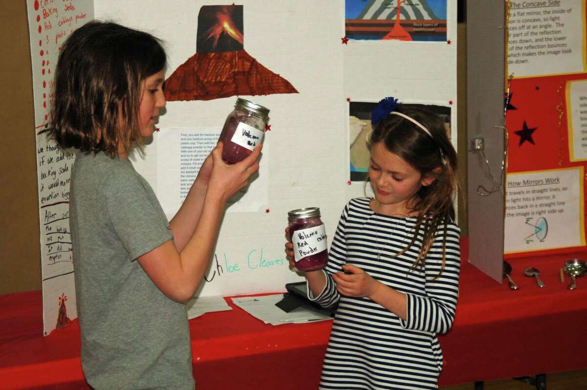 Chloe Cleaves, left, and Annalyn Pacifico, right, led a presentation on their volcano experiment for their third grade class at the recent Riverside School STEM fair.