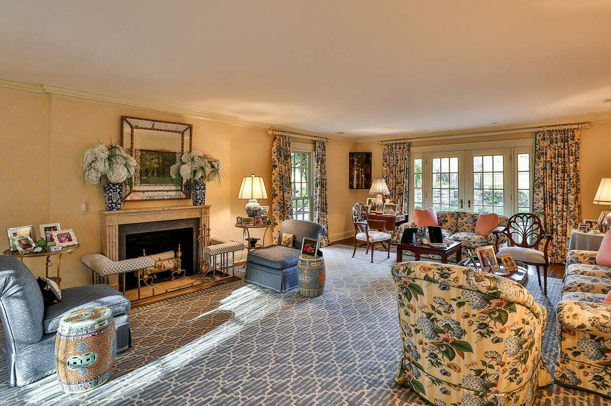 Almost every room along the back of the house, including this spacious formal living room features French doors that open to the patios, grounds, and gardens.