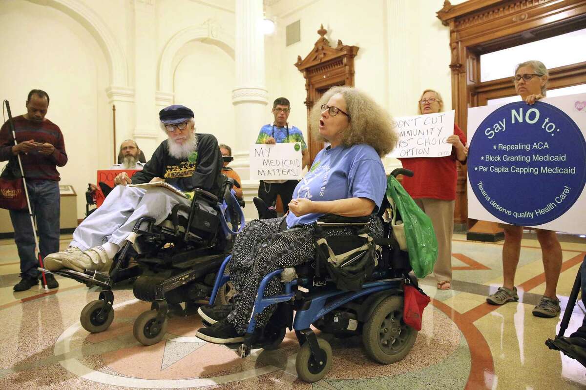 Stephanie Thomas comes forward to speak her mind as disabled citizens and supporters assemble in front of Gov. Abbott's office in the State Capitol to urge the governor to use his influence to get the Congress to reject the American Health Care Act on March 22, 2017. Bob Kafka (left center) an organizer for listens with about 15 other demonstrators Wednesday afternoon.
