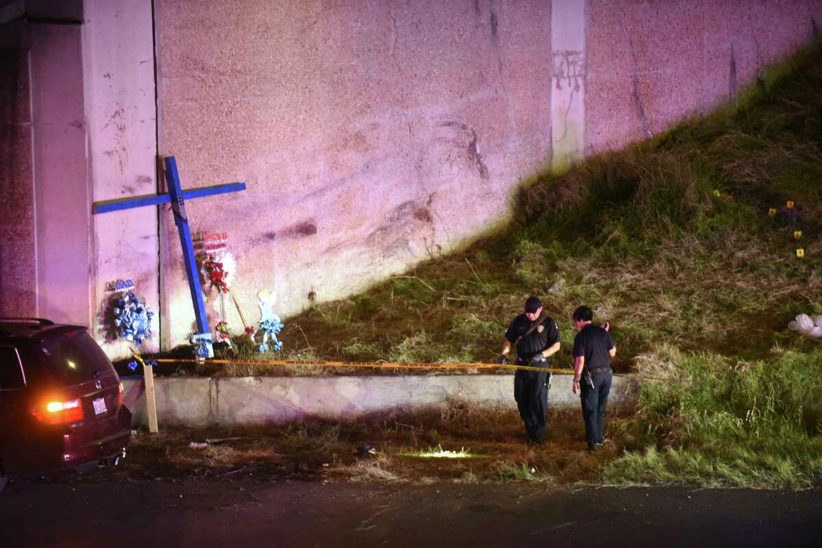 Police investigate the scene where a woman was attacked as she worked on a cross the edge of Highway 281 beneath the Hildebrand overpass on Wednesday night, March 22, 2017.
