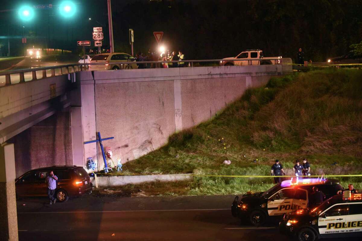 Police investigate the scene where a woman was attacked as she worked on a cross on the edge of Highway 281 beneath the Hildebrand overpass on Wednesday night, March 22, 2017.