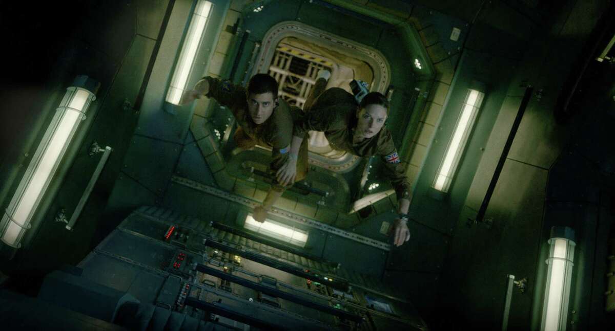 Jake Gyllenhaal and Rebecca Ferguson float through the space station in “Life.”