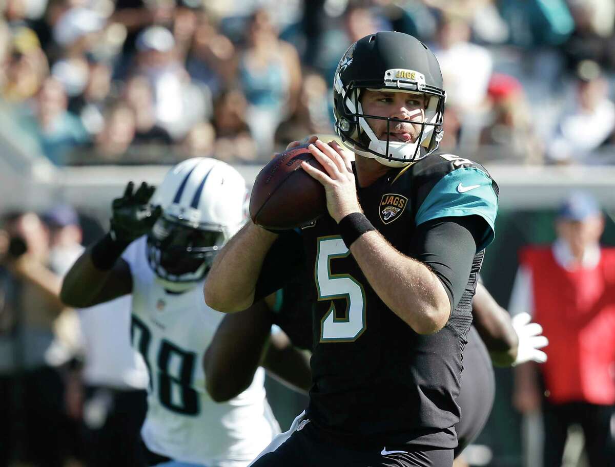 Jacksonville Jaguars quarterback Blake Bortles (5) looks for a receiver as he is pressured by Tennessee Titans outside linebacker Brian Orakpo (98) during the first half of an NFL football game, Saturday, Dec. 24, 2016, in Jacksonville, Fla. (AP Photo/John Raoux)
