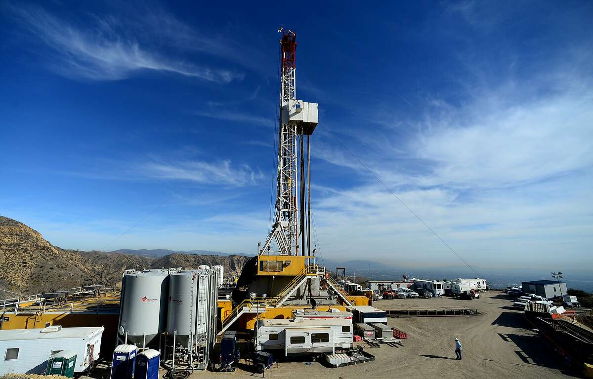 FILE - In this Dec. 9, 2015 file photo, crews work on a relief well at the Aliso Canyon facility above the Porter Ranch area of Los Angeles. The escape of tons of natural gas from under a Los Angeles neighborhood is taking months to stop because of pressure from the leak. The leak at Porter Ranch started in October, and likely won�t be fixed for at least two more months. Officials have relocated several thousand residents who said the stench made them sick. (Dean Musgrove/Los Angeles Daily News via AP, Pool, File)