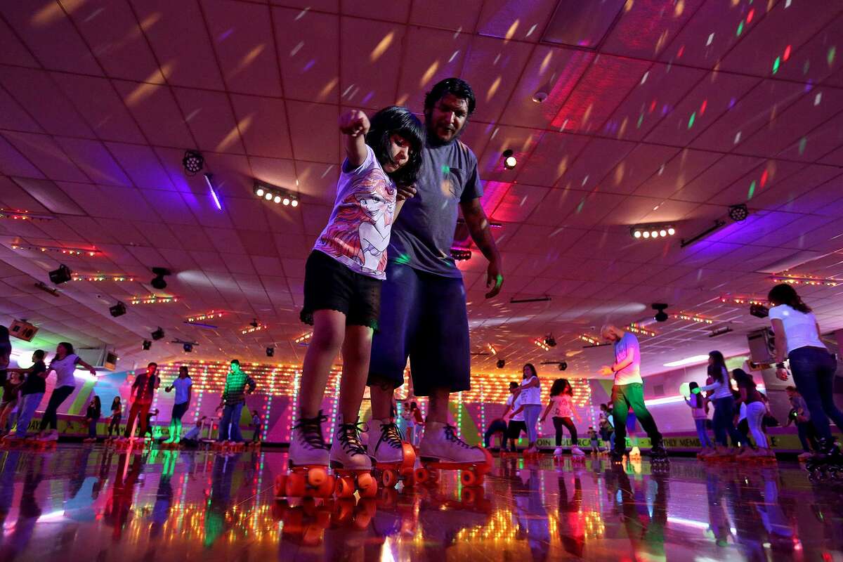 David Chavez helps his daughter Annabell Chavez, 6, skate at The Rollercade, where even grandparents sometimes share a skate with their kids and grandchildren.