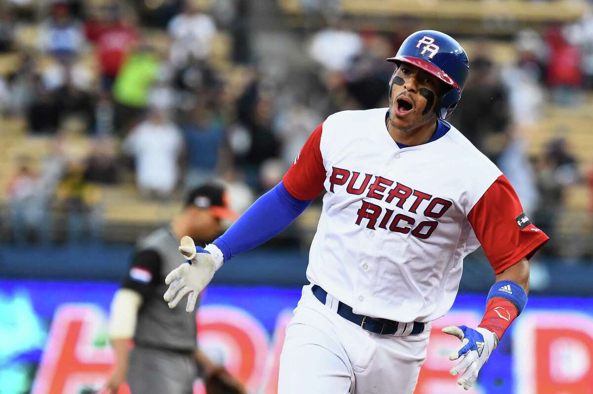 Puerto Rico's Carlos Correa rounds the bases after his two-run homer Monday against the Netherlands.