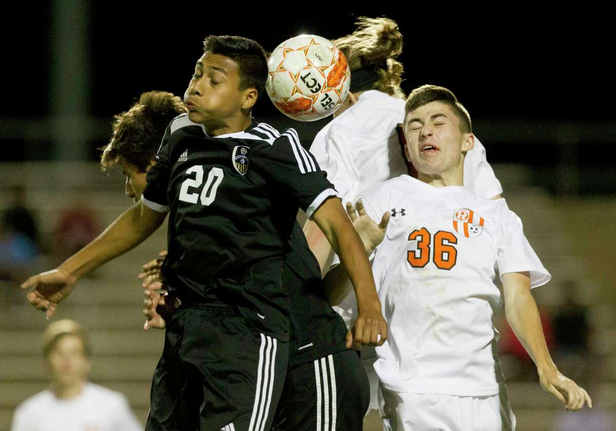 Conroe defender Justin Meza (20) attempts a header against Rockwall midfielder Harper Roland (36) during the second period of Region II-6A bi-district high school soccer playoff match at Palestine High School Thursday, March 22, 2017, in Palestine. Rockwall defeated Conroe 2-1.