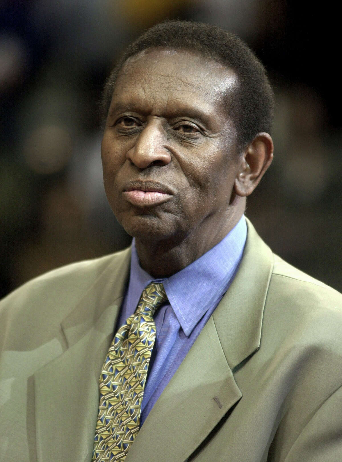 In this Apirl 23, 2003, file photo, Earl Lloyd is honored at halftime of the Detroit Pistons-Orlando Magic NBA basketball playoff game in Auburn Hills, Mich. Lloyd, the first black player in NBA history, died Thursday, Feb. 26, 2015. He was 86. Lloyd's alma mater, West Virginia State, confirmed the death. It did not provide details. Lloyd made his NBA debut in 1950 for the Washington Capitals, just before fellow black players Sweetwater Clifton and Chuck Cooper played their first games. (AP Photo/Paul Sancya, File)