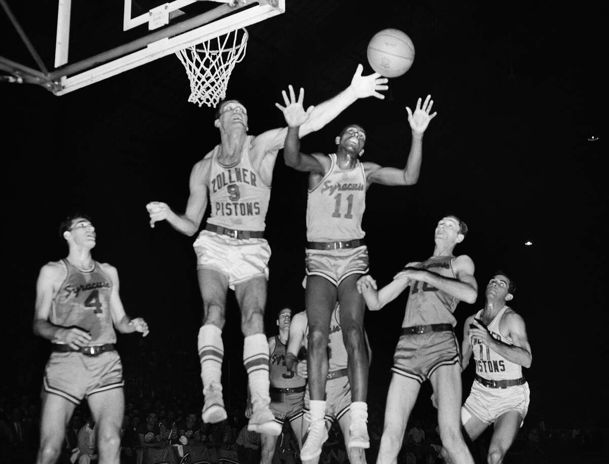 Earl Lloyd, nicknamed 'The Big Cat,' is the subject of a documentary film featuring Kawhi Leonard and co-produced by Leonard and Tony Parker. In this 1955 photo, Fort Wayne's Mel Hutchins (9) and Syracuse's Lloyd (11) reach for the ball during an NBA basketball game in Indianapolis. (AP Photo/File)