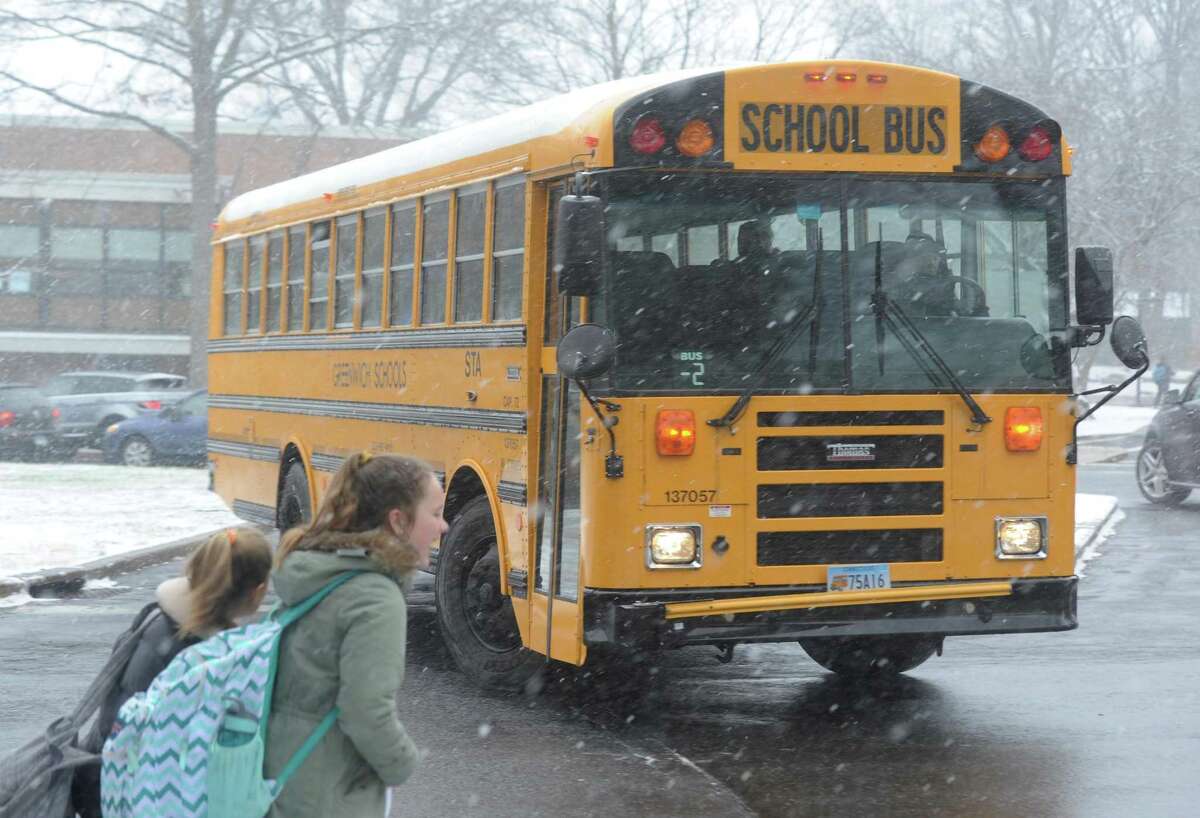 A school bus departs Eastern Middle School after an early dismissal due to snow in the Riverside section of Greenwich, Conn. Tuesday, Jan. 31, 2017.