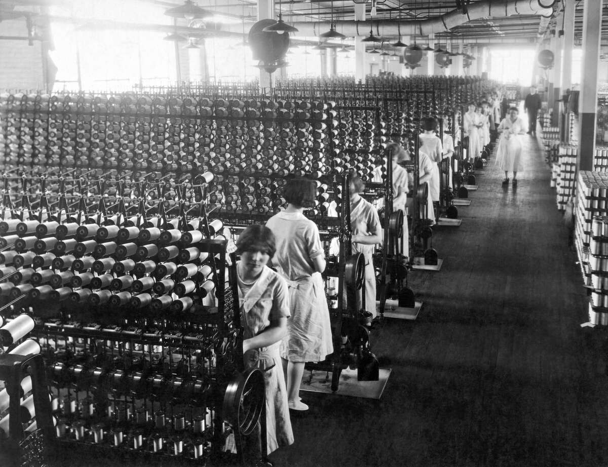 Women working at silk winding machines that will be used in the manufacturing of ladies hosiery, Connecticut, circa 1921. (Photo by Underwood Archives/Getty Images)