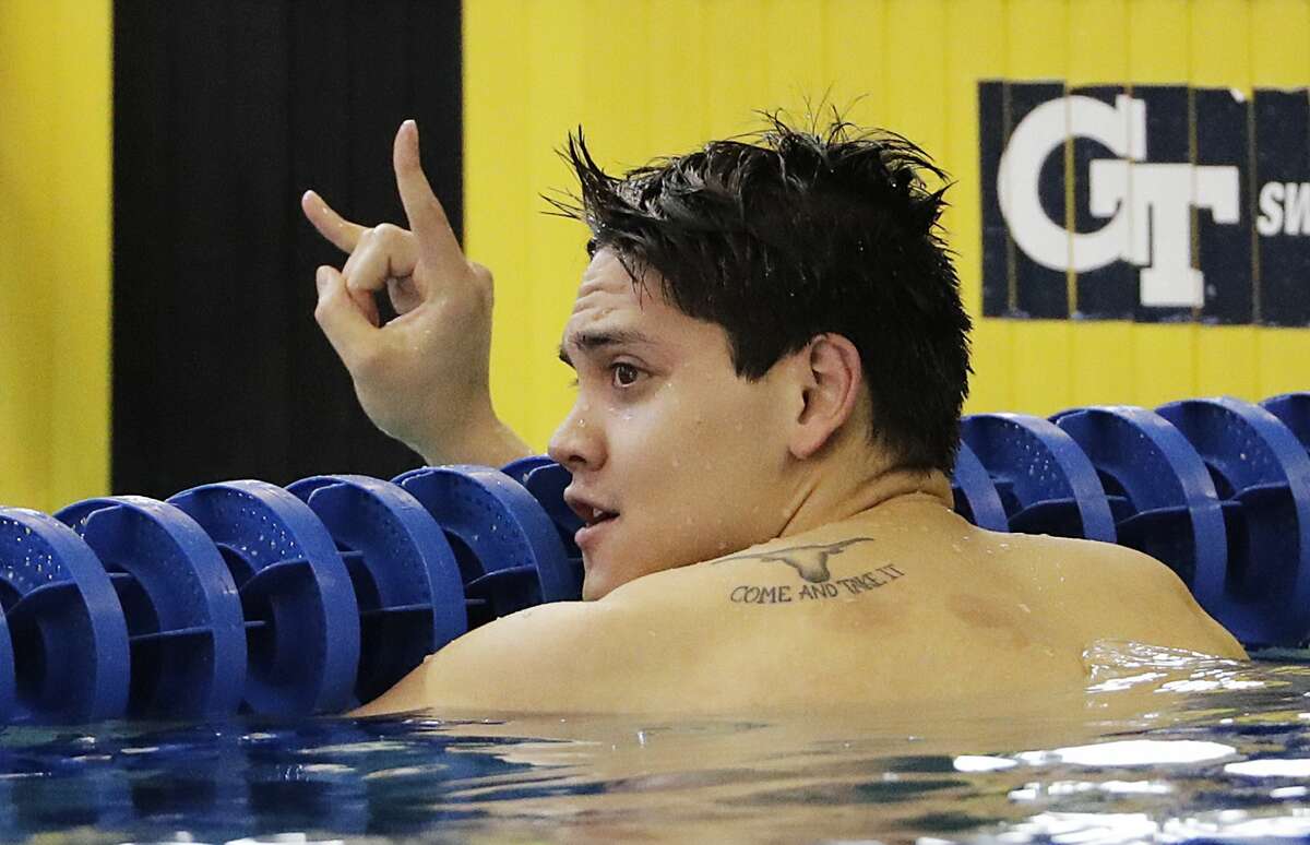 Texas' Joseph Schooling gestures after winning the 100-yard butterfly at the NCAA men's swimming and diving championships at Georgia Tech, Friday, March 25, 2016, in Atlanta. (AP Photo/David Goldman)